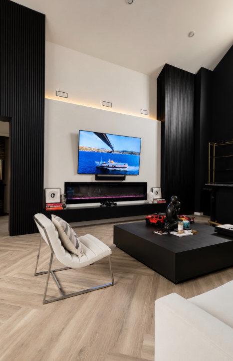 Custom luxury black slat feature wall with linear fireplace and media wall by Obsidian Walls in a DFW home